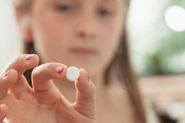 Girl holding a tablet ADHD treatment psychiatry killing your children